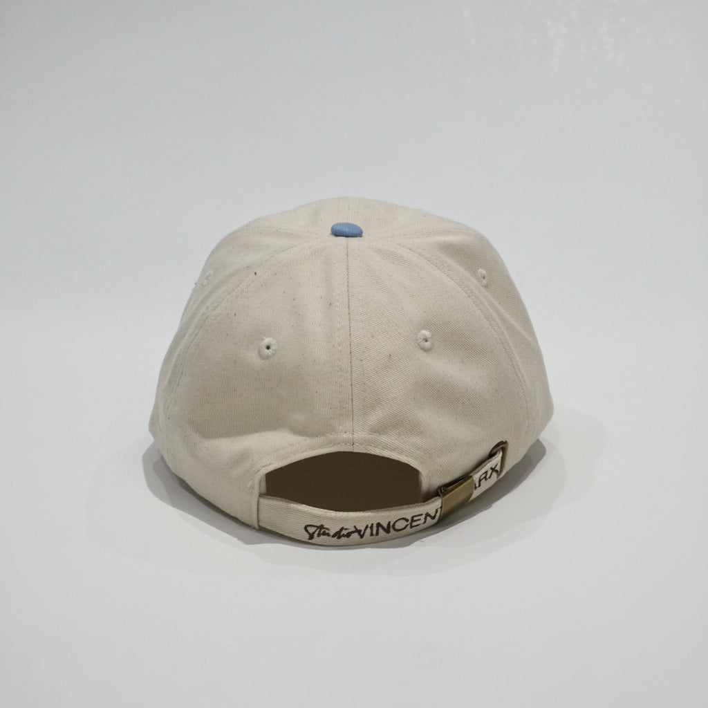 Cap Blue/Creme von hinten mit verstellbarem Riemen